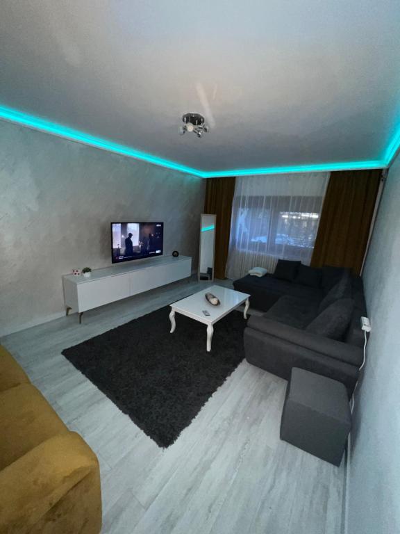 a living room with a couch and a tv at holiday apart in Oradea