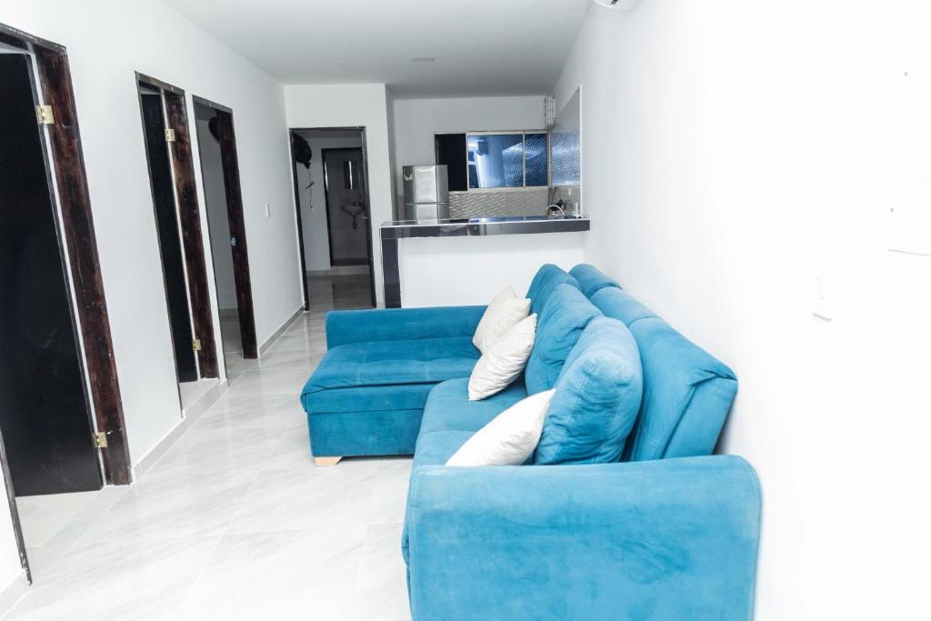 a blue couch sitting in a living room at Apartamentos King Arthur in Punta Seca