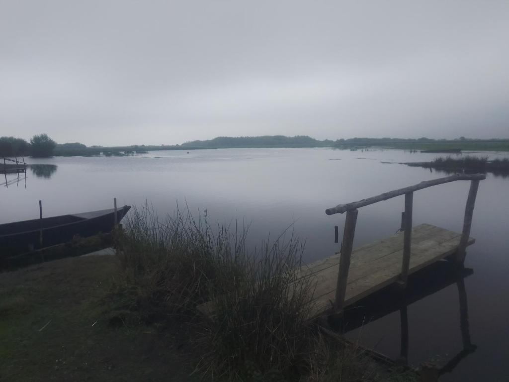 a body of water with a dock in the middle at La Chambre Périgourdine in Journiac