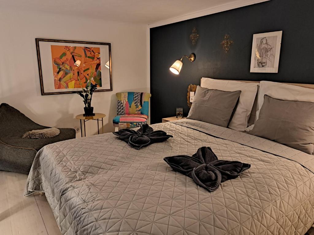a bedroom with a bed with black towels on it at Bárka Home in downtown Buda in Budapest