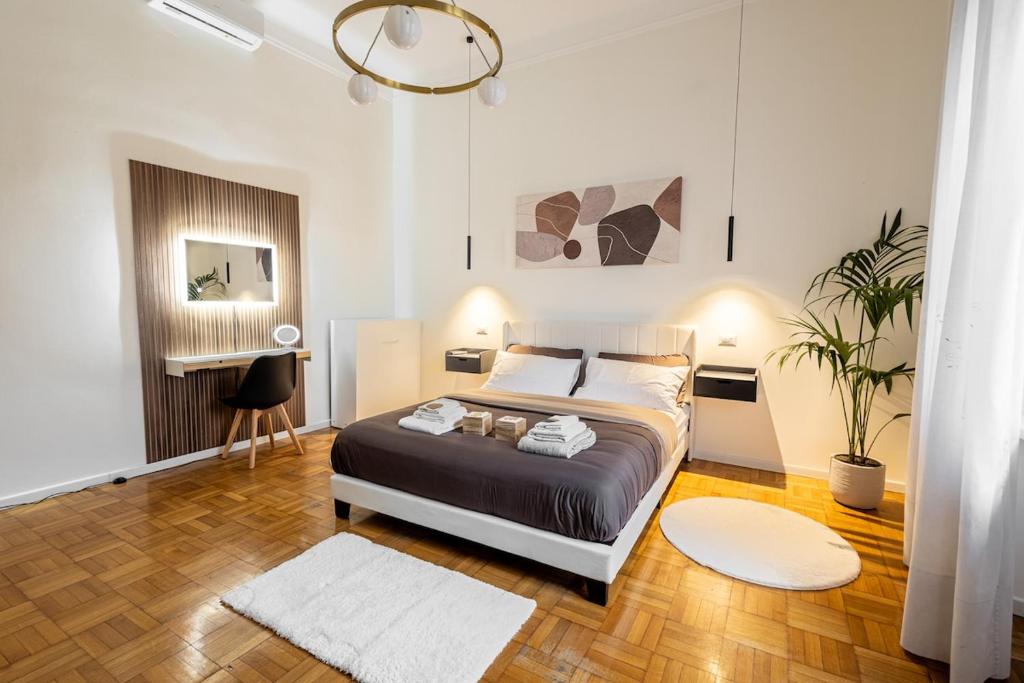 a bedroom with a bed and a desk in it at B&B di Dante in Legnano