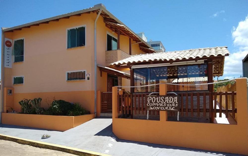 a house with a sign in front of it at Pousada Convés das Ondas in Penha