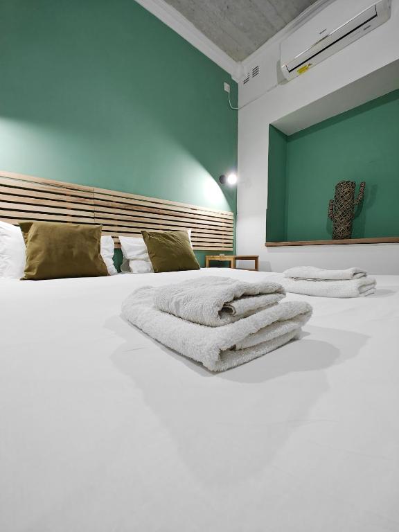 a large white bed with towels on top of it at Cosy room 4 in Pieta