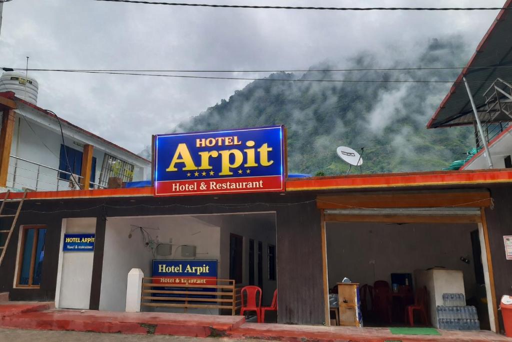 a sign on the front of a hotel apartment at Hotel Arpit in Sonprayag