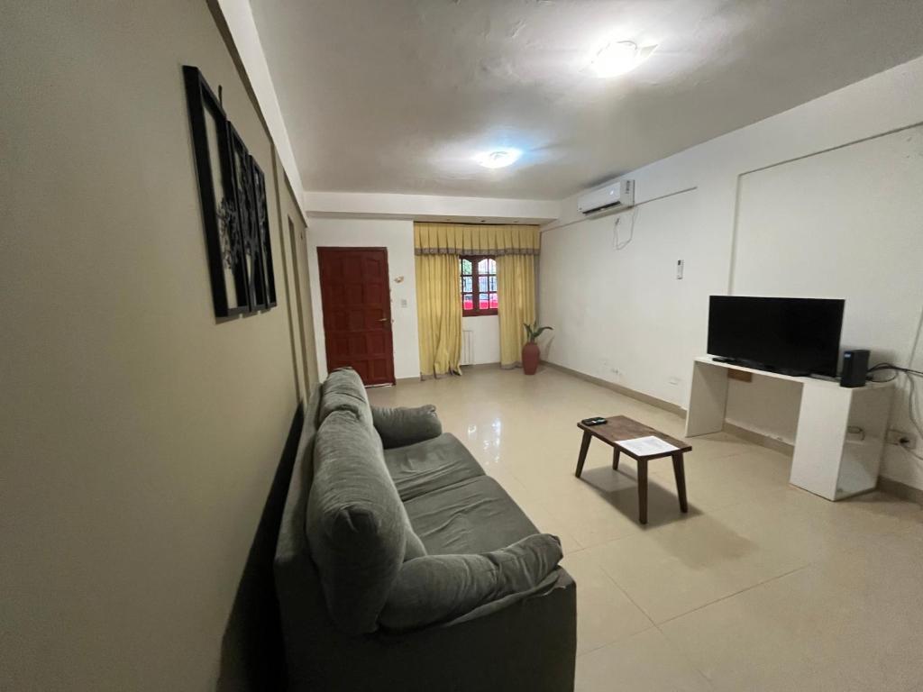 a living room with a couch and a tv at Casa balcarce in Salta
