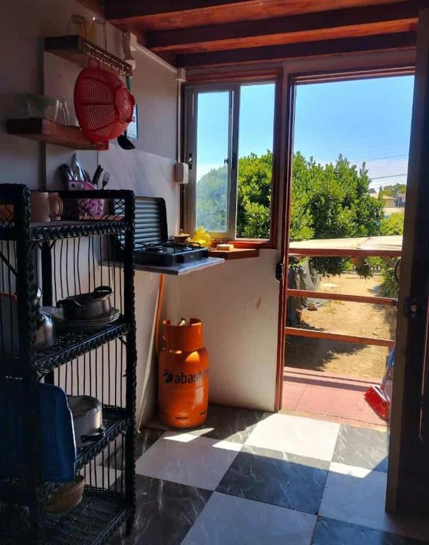 a kitchen with an open door and a window at Loft centro de el tabo in El Tabo