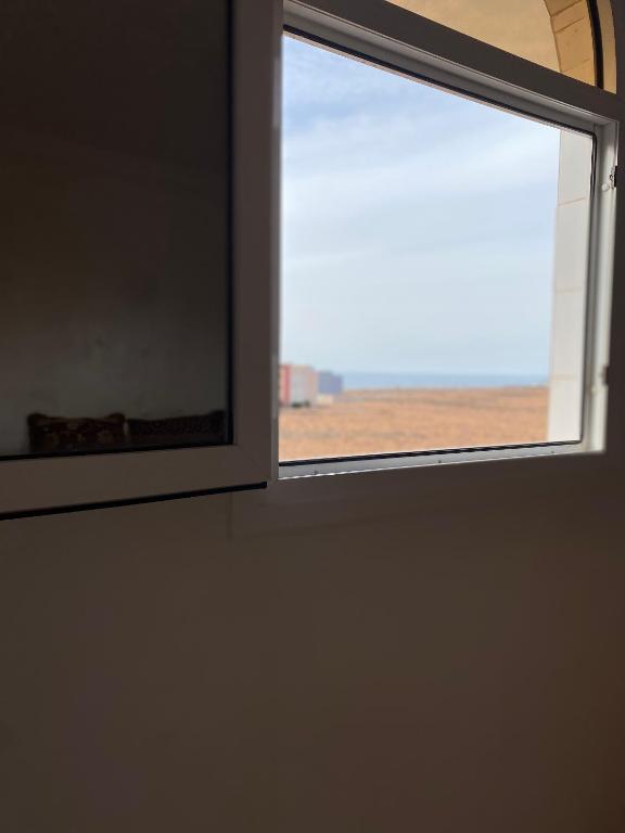 a window in a room with a view of a field at Ahmed mirleft in Sidi Ifni