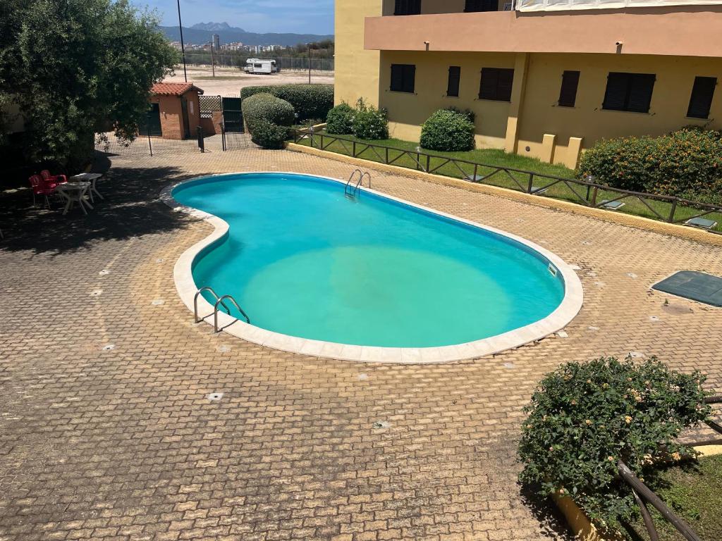 a large swimming pool in a brick yard at Casa Nietta in Olbia