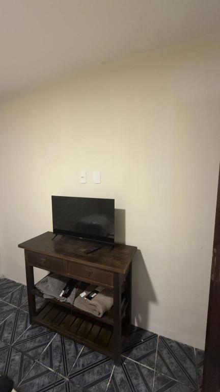 a tv sitting on a table in a room at Casa maricota in Porto Seguro