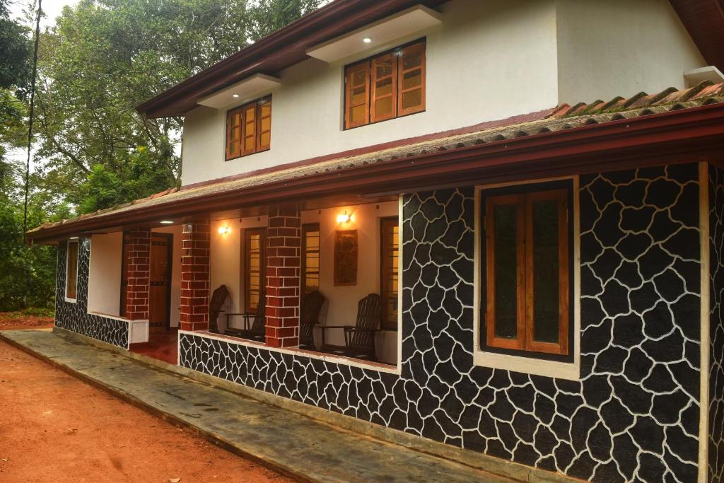 a house with a black and white facade at Patrius Bungalow by Daddy's Nest in Diyatalawa