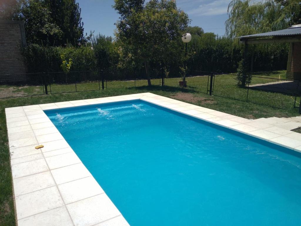 a large blue swimming pool in a yard at La finca in San Rafael