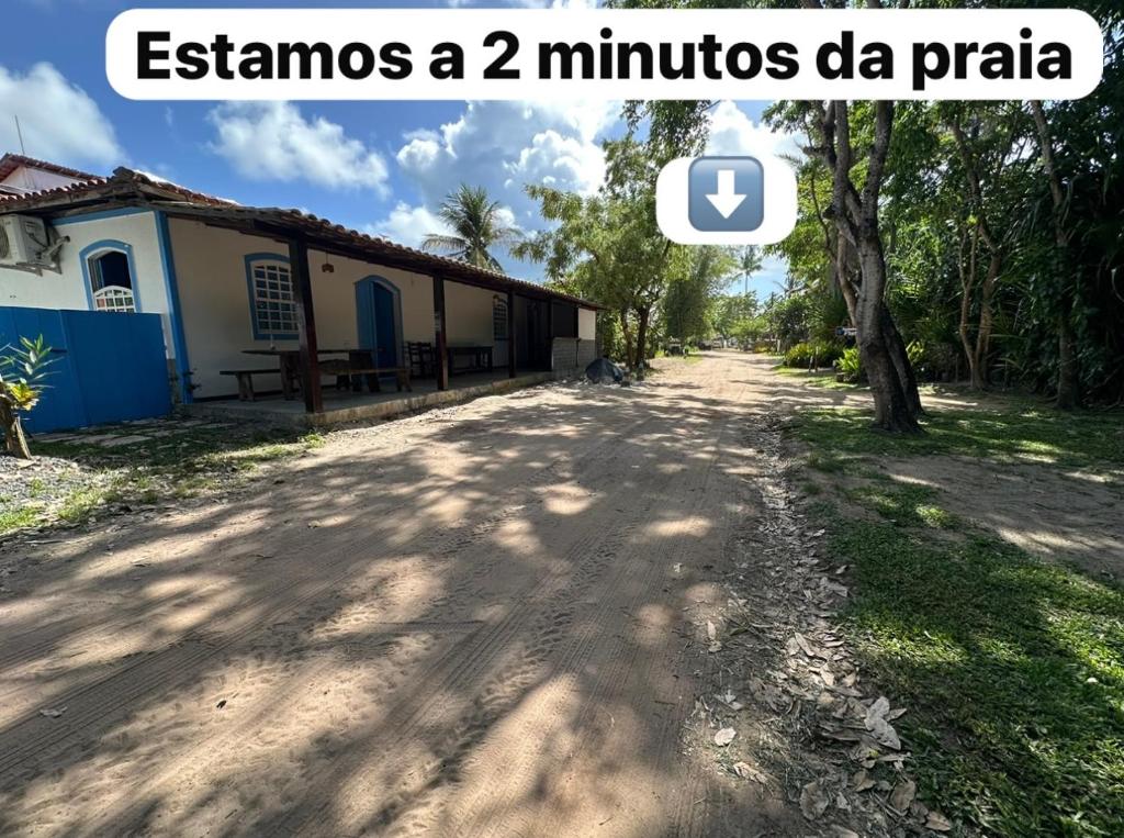 a dirt road next to a building with a tree at San Sebastian Taipu de Fora in Marau