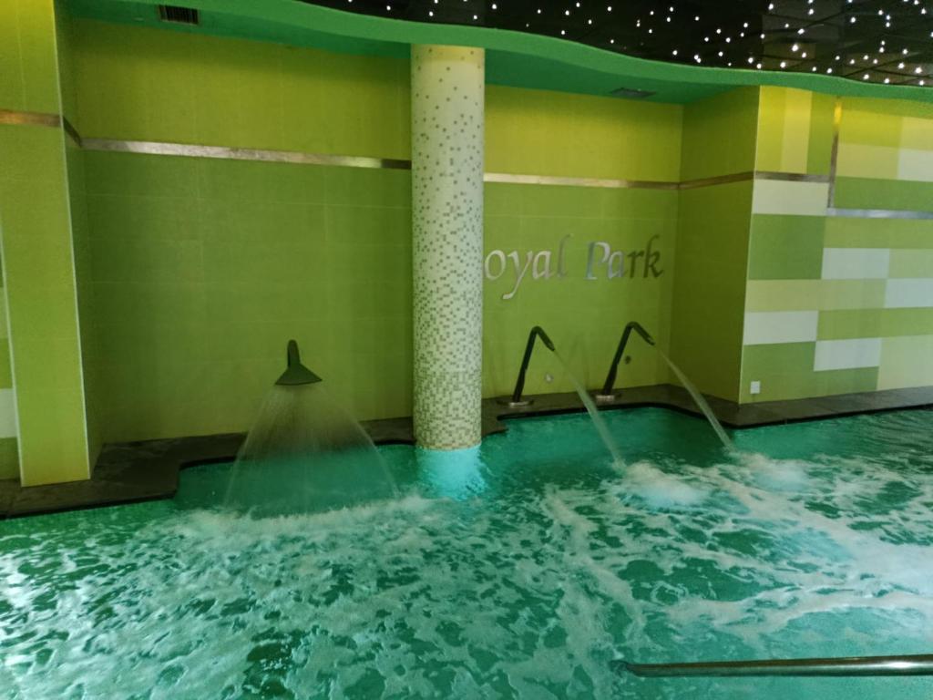a swimming pool with water being poured into it at Royal Park Green Spa in Orihuela Costa