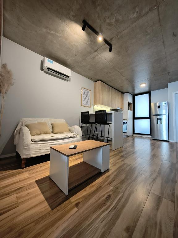 a living room with a couch and a table at Canela Loft Rosario in Rosario