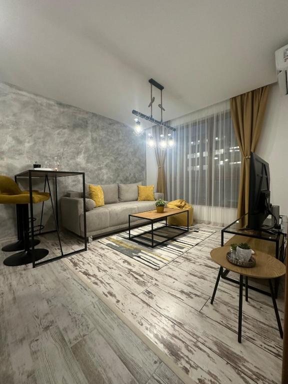 a living room with a couch and a table at Le Bijou МОЛ Плаза in Plovdiv