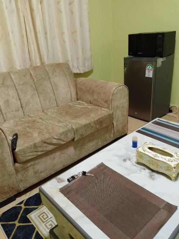 a living room with a couch and a table at Venguest Homes & Accomodation in Naivasha