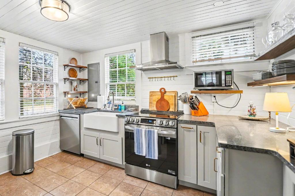 a kitchen with stainless steel appliances and white walls at Beaufort 308 Charles in Beaufort