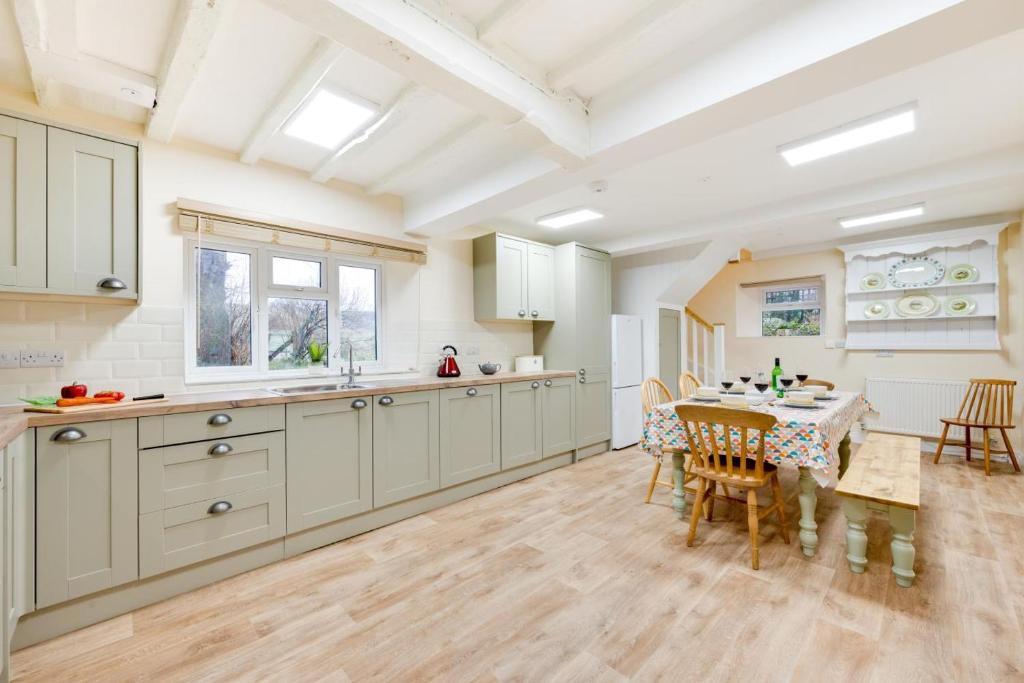 a kitchen with a table and a dining room at 3 Bed in Machynlleth oc-bow306 in Darowen