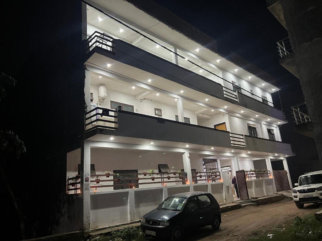 a car parked in front of a building at night at BNT BOYs HOSTEL in Lucknow