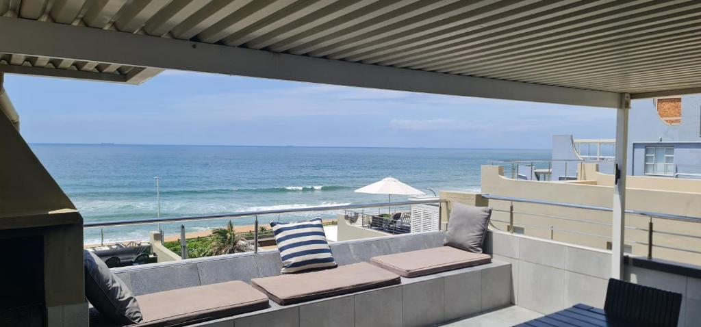 a balcony with a view of the ocean at VayKZN Umdloti in Umdloti