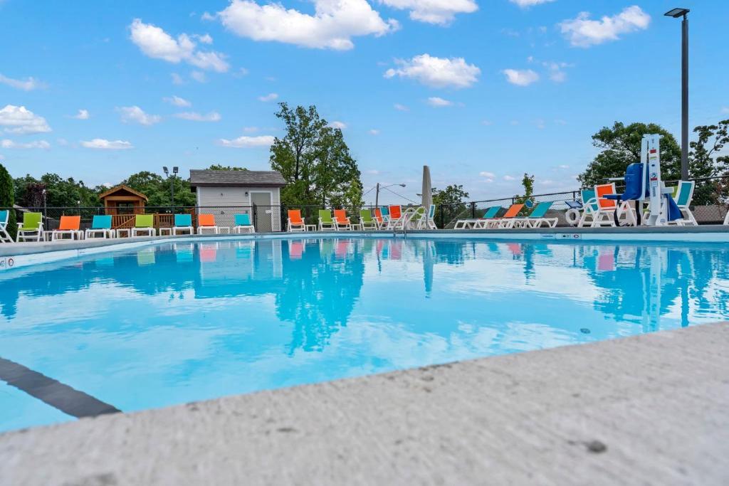 a swimming pool with chairs and a playground at Lakin it Easy Condo for 2 in Kimberling City
