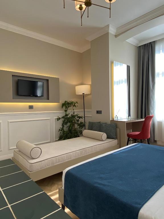 a bedroom with a bed and a tv on a wall at Pera Standard Rooms in Istanbul
