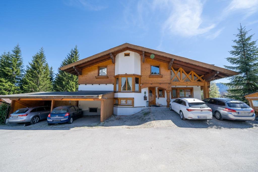 a house with cars parked in front of it at Haus Martin Appartement Eichhörnchen in Ramsau am Dachstein