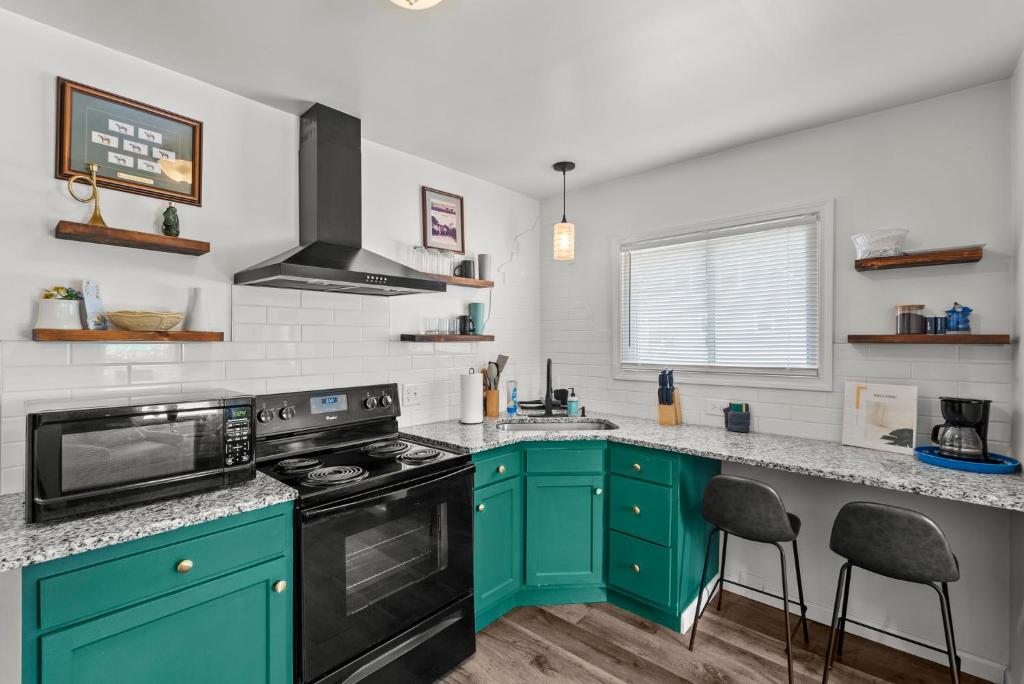 a kitchen with green cabinets and a stove top oven at Mint Julep - Studio in Downtown Lexington in Lexington