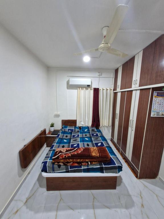 a room with a bed with blue tiles on it at Laximi Niwas in Nashik
