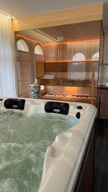 a jacuzzi tub in the middle of a room at APETIKO APARTMENTs in Kyiv