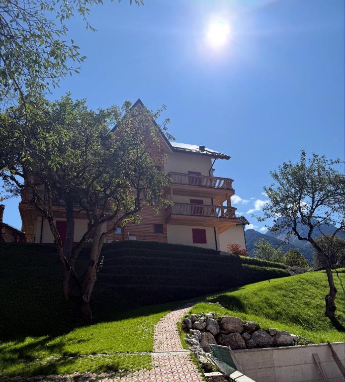 a house on a hill with a path in front at Rosetta - Ai Meli - Dolomites in Lozzo Cadore