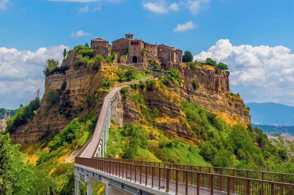 a castle on top of a mountain with a bridge at Luce su Civita in Lubriano