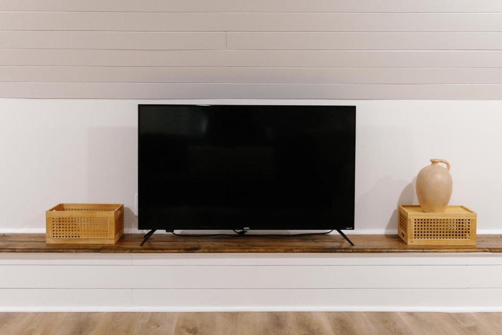 a flat screen tv sitting on a shelf at Seabiscuit Loft - Studio in Downtown Lexington in Lexington