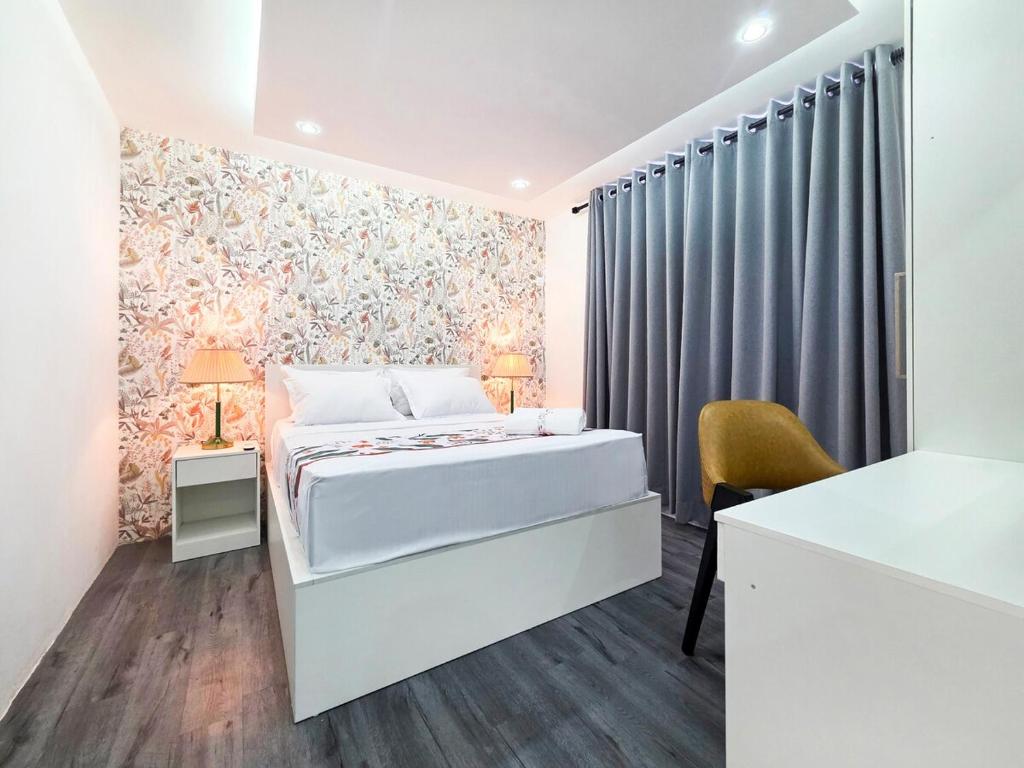 a bedroom with a bed and a table and a chair at Evolve SAYA in Talawatugoda