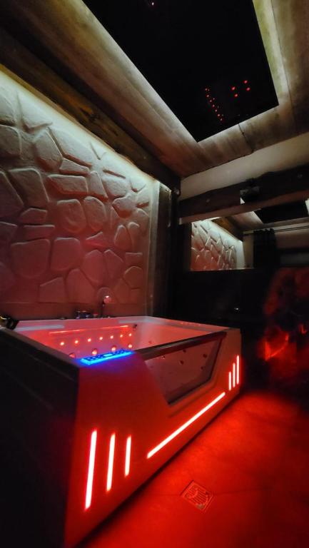 a pool table in a room with red lights at Cudodomek SPA Loft koło Ełku in Ełk