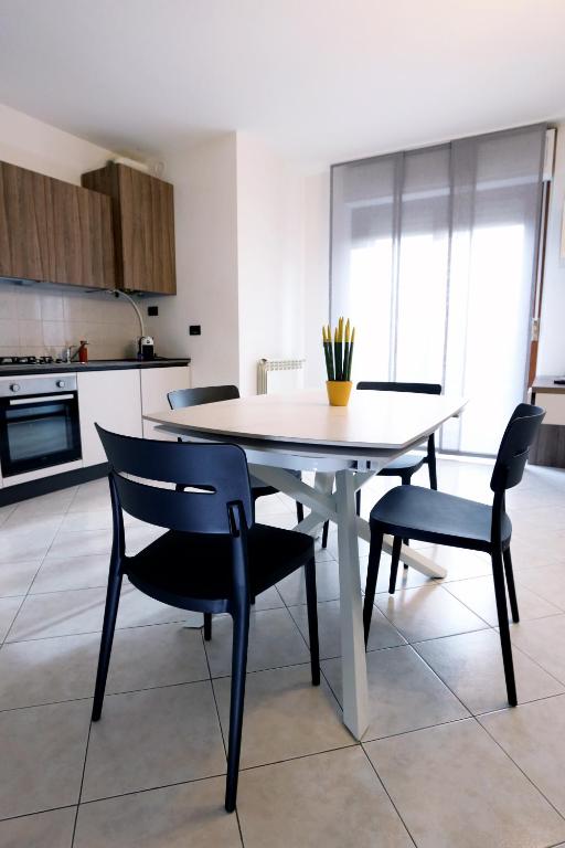 a dining room table and chairs in a kitchen at Armanni's House in Orio al Serio