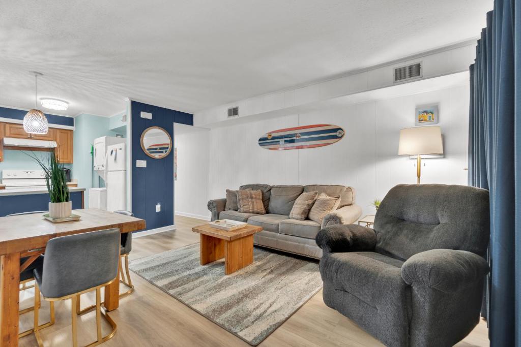 a living room with a couch and a table at Fenwick Woods OC in Ocean City