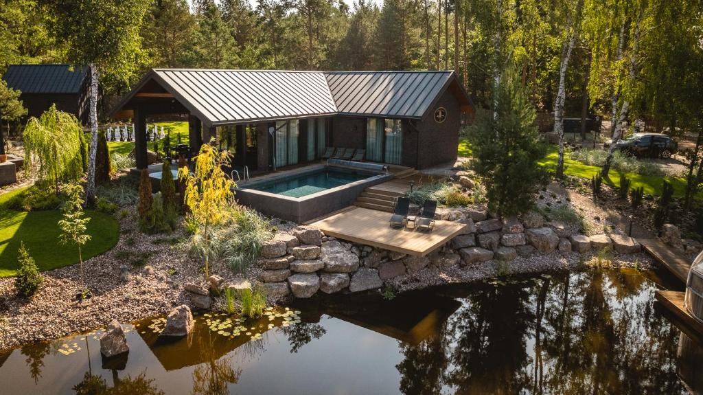 an aerial view of a house with a pond at Sherlock Home in Czarnówiec