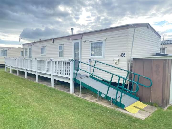a mobile home with a staircase leading to it at 10 Berth Caravan - Meadow View in Skegness