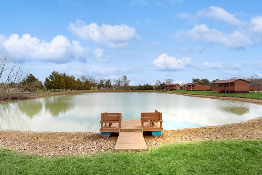 a bench sitting in the middle of a pond at Pet Friendly! Couples Retreat in Southern Illinois in Etherton
