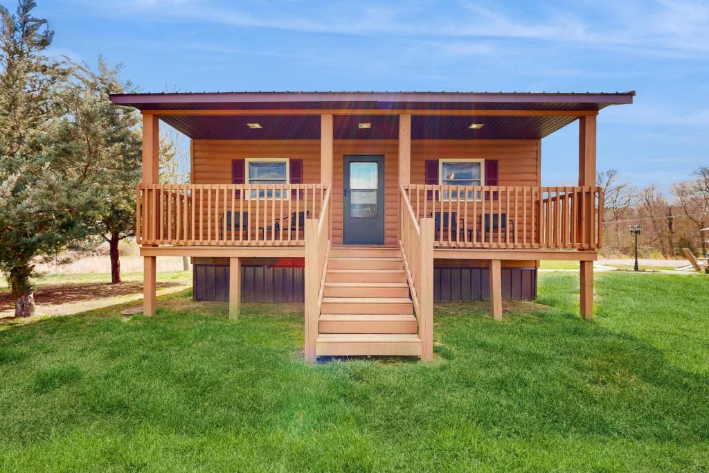 a log cabin with two decks on the grass at Pet Friendly! Countryside Couples Stay in Illinois in Etherton