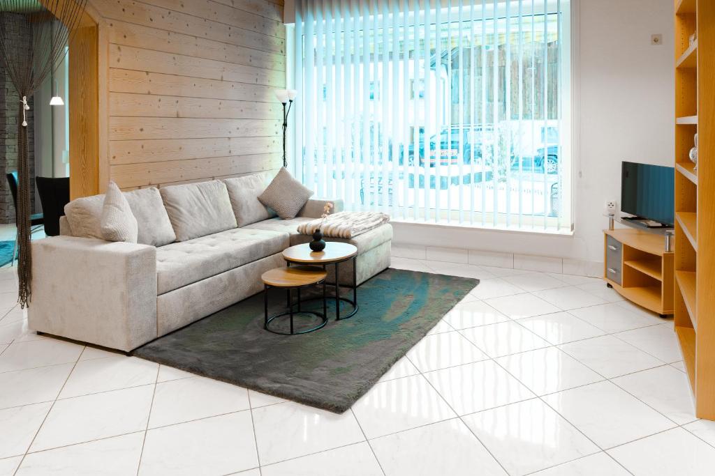 a living room with a couch and a table at Haus Treff in Weissenbach am Lech