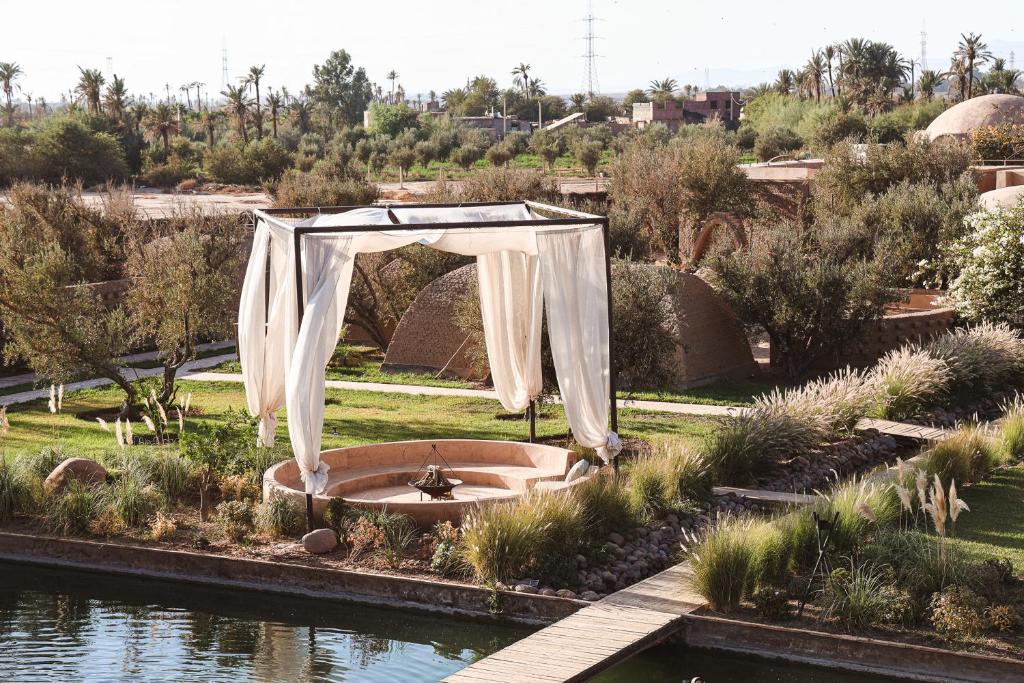 an arch with a fountain in the middle of a garden at Bliss Terra Janna in Marrakesh