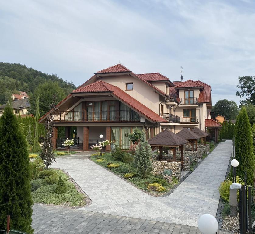 a large house with a walkway in front of it at Willa Fox - Wisła Centrum in Wisła