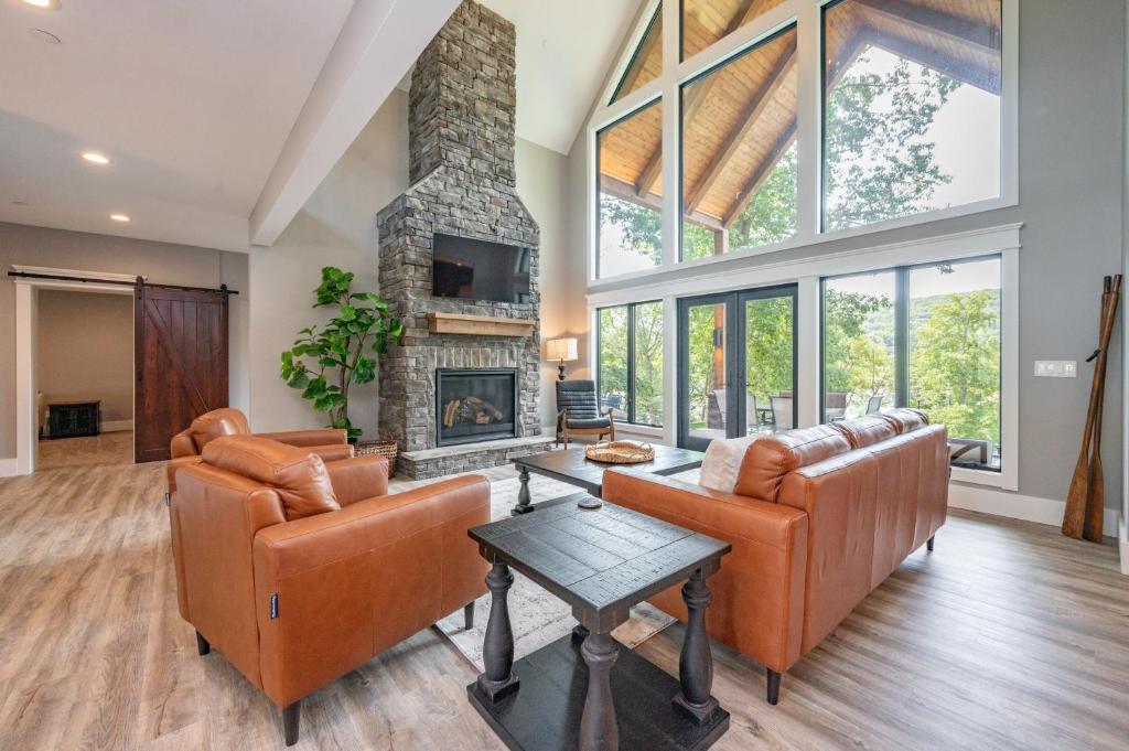 a living room with two couches and a fireplace at Whispering Pines by Railey Vacations in McHenry