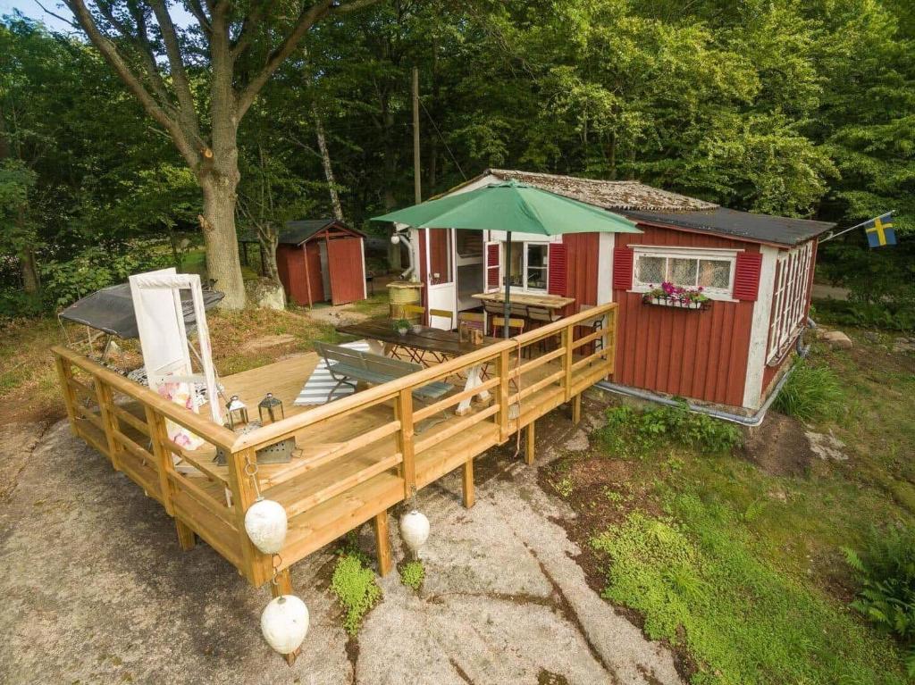 a tiny house with a porch and a deck at BLE849-Ronneby-Rustorpsvaegen-1 in Ronneby