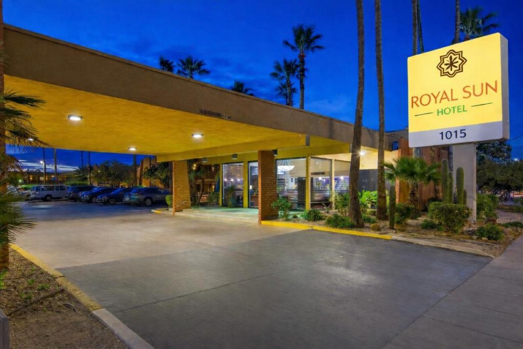 a royal sun hotel with a sign in front of it at Royal Sun Hotel & Suites in Tucson