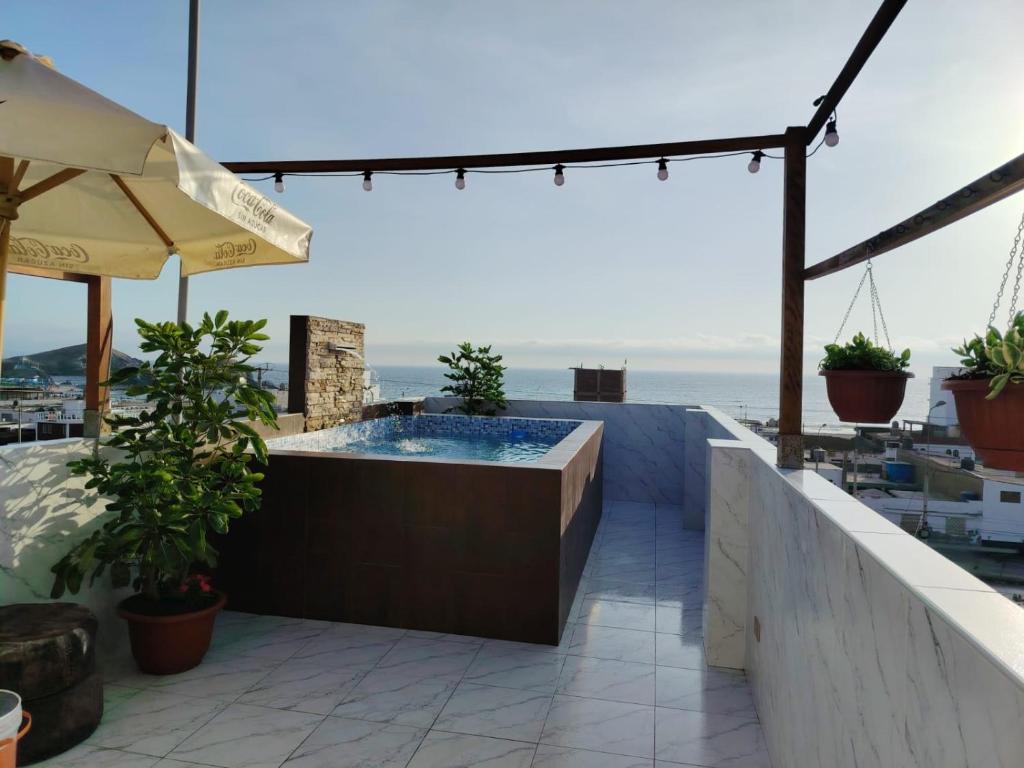 a hot tub on a patio with a view of the ocean at Ocean Glips II in Punta Negra
