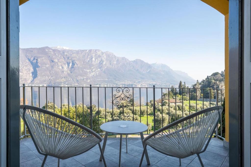 a table and two chairs on a balcony with a view at Ca Maria Peonie Apartment in Bellagio