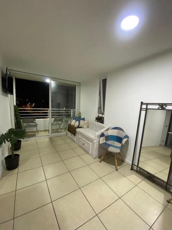 a living room with a couch and a window at Arena Marina-Sol l in El Cerrillo